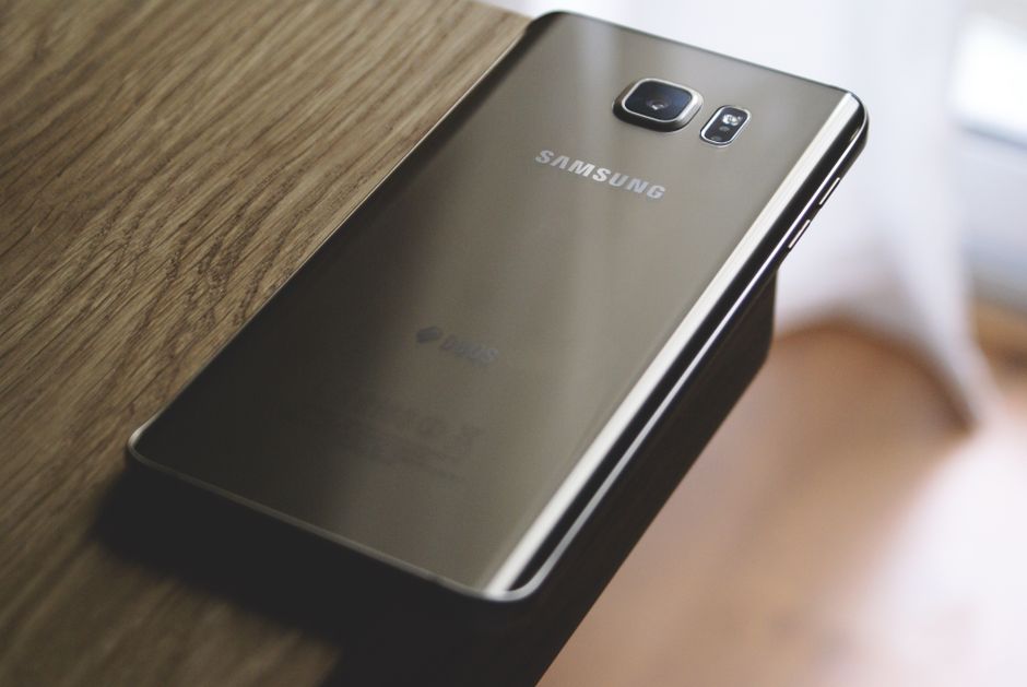 Samsung — stock photo by John (Giannis) Tekeridis via Pexels (https://www.pexels.com/photo/silver-samsung-galaxy-smartphone-on-top-of-brown-wooden-table-214488/)