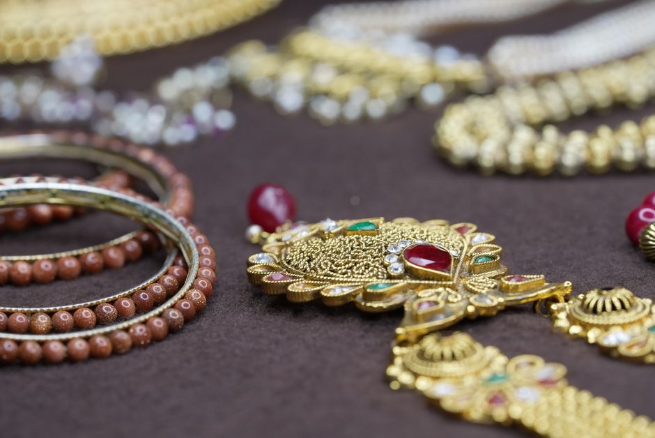 Jewellery and Gold — stock photo by Kunal Lakhotia via Pexels (https://www.pexels.com/photo/close-up-of-ornate-traditional-jewelry-on-display-37485313/)