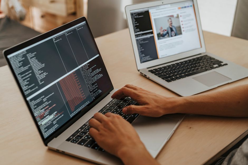 Laptops — stock photo by olia danilevich via Pexels (https://www.pexels.com/photo/person-coding-on-a-macbook-pro-4974912/)
