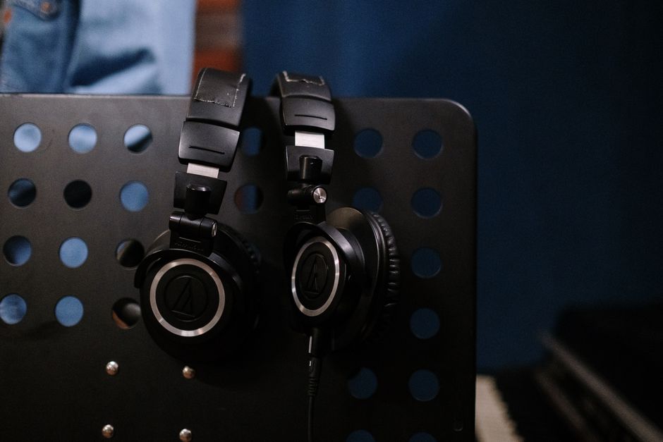 Audio — stock photo by cottonbro studio via Pexels (https://www.pexels.com/photo/close-up-of-headphones-hanging-on-a-metal-wall-5650531/)